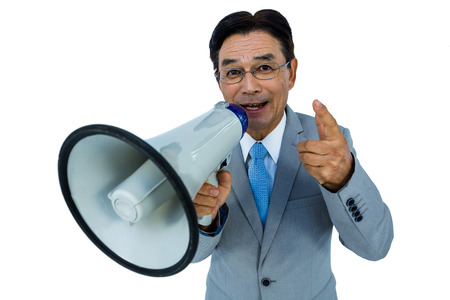 Asian businessman talking through megaphone on withe backgroundの写真素材