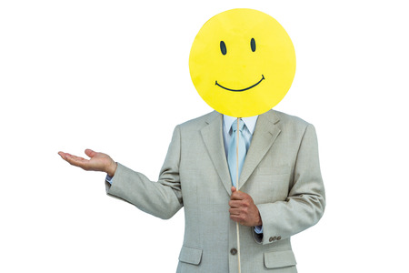 Businessman holding happy smiley face balloon on white backgroundの写真素材