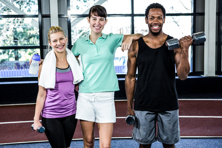 Fit smiling people standing together in crossfitの写真素材