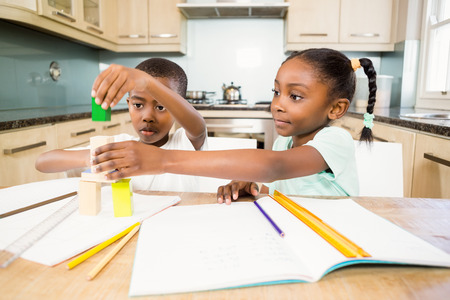 Children doing homework in the kitchenの写真素材
