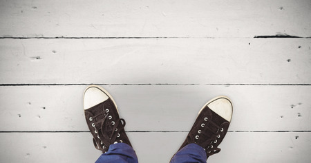 Man standing on hardwood floor against white wood