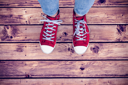 Casual shoes against wooden planks backgroundの写真素材