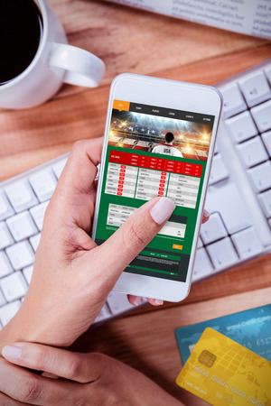 Credit Card against businesswoman using her smartphone on deskの写真素材