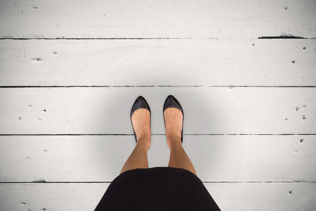 Businesswomans feet against white woodの写真素材
