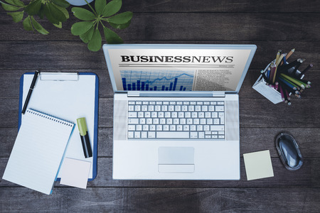 View of a business desk against business newspaperの写真素材