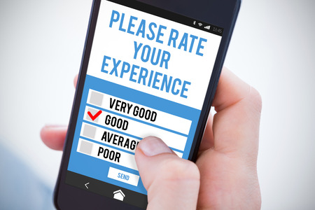 Woman using her mobile phone against telephone test appの写真素材