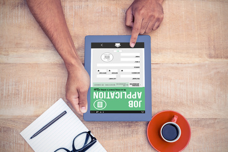 Job application on smartphone   against overhead view of person holding on digital tabletの写真素材
