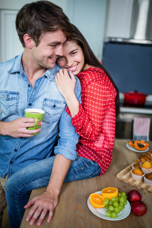 Happy couple having breakfast together at homeの写真素材