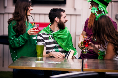Friends celebrating St Patricks day with drinks in a barの写真素材