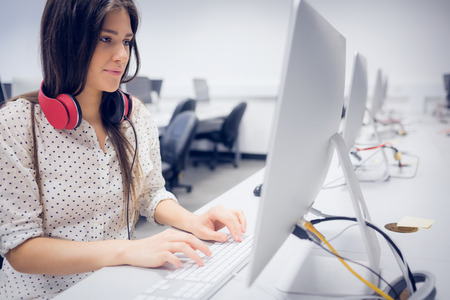 Serious student working on computer at university