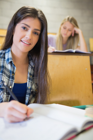 Serious students working in class in universityの写真素材