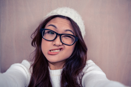 Asian woman making faces and looking at the cameraの写真素材