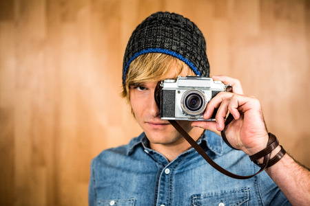 Serious hipster man taking picture with digital cameraの写真素材