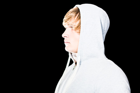 Side view of serious man looking away with black backgroundの写真素材