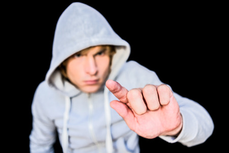 Man in hood jacket on black backgroundの写真素材