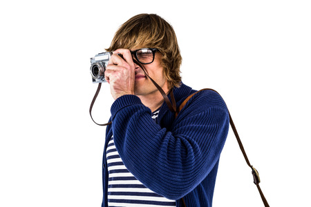 Hipster taking pictures with an old camera on white scren