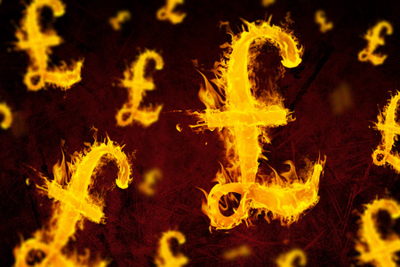 British pound on fire  against dark backgroundの写真素材