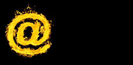 At in fire against blackの写真素材