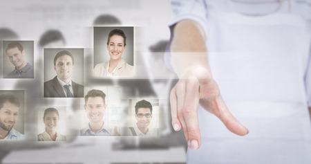 Woman pointing with her finger  against greyの写真素材