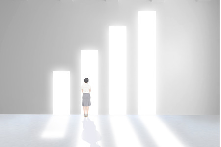 Businesswoman standing against graph shapeの写真素材