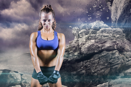 Portrait of confident woman against rock crashing down from cliffの写真素材
