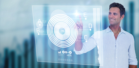 Man pointing at something on white background  against digital pie chart Handsome man pointing at...
