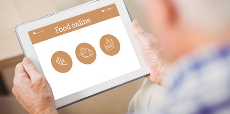 Food app against senior man using tabletの写真素材