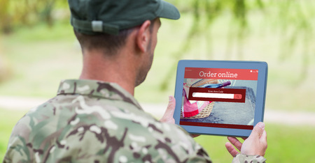 Army man using tablet against food appの写真素材