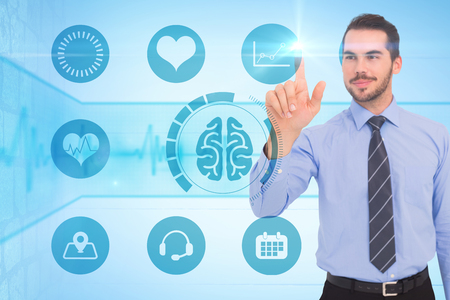 Happy businessman standing and pointing up against medical background with blue ecg lineの写真素材