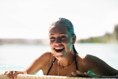 Beautiful blonde in the pool smiling and breathing