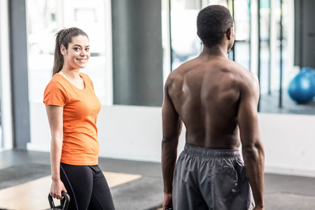Athletic man and woman working out at crossfit gymの写真素材