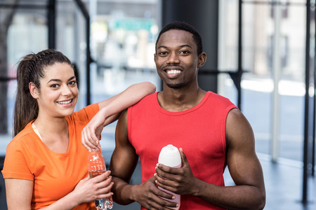 Smiling woman and man after effort at crossfit gymの写真素材