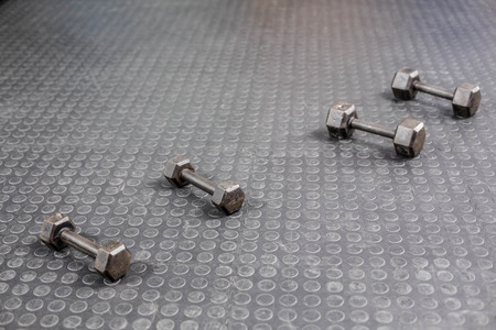 Four dumbbells next to each other at crossfit gymの写真素材