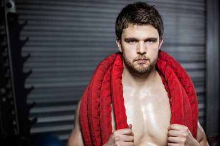 Man with rope around his neck at crossfit gym