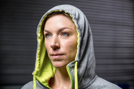 Portrait of woman wearing hood at crossfit gymの写真素材
