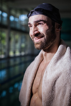 Smiling man looking at something at the poolの写真素材