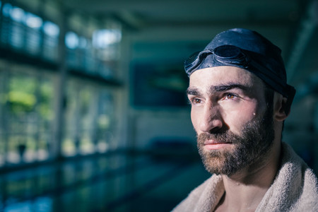 Serious man looking at something at the poolの写真素材