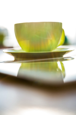 Close up of a coffee cup and tablet pc on a tableの写真素材