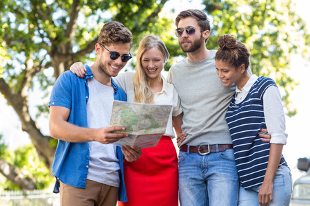 Hip friends checking map outdoorsの写真素材