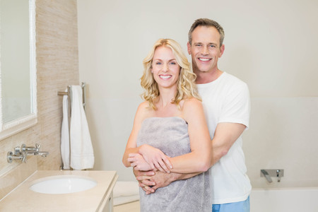 Cute couple hugging in the bathroomの写真素材