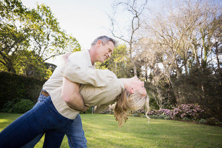 Cute couple dancing in the gardenの写真素材
