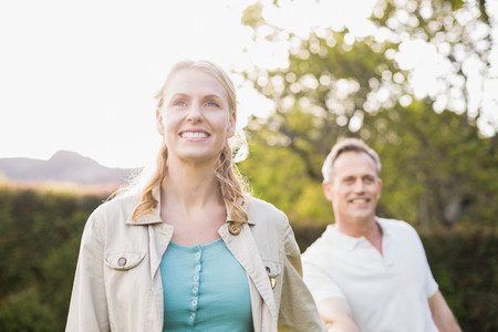Cute couple holding hands in the gardenの写真素材