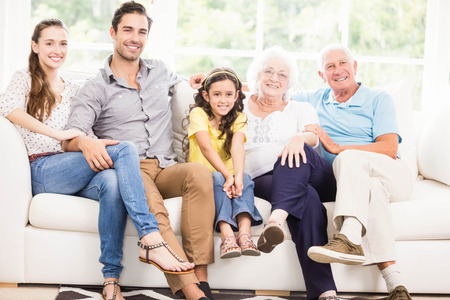 Happy extended family smiling at home