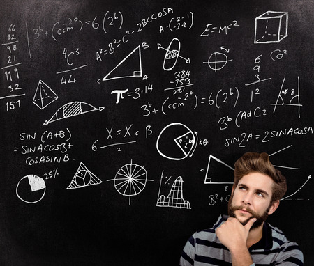 Close-up of thoughtful hipster with hand on chin against black backgroundの写真素材