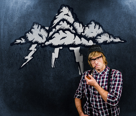 Serious blond hipster smoking a pipe against black backgroundの写真素材