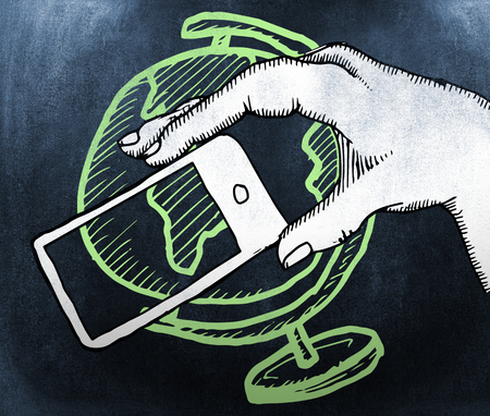 Hand holding smartphone against black backgroundの写真素材