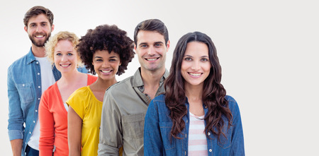 Group portrait of happy young colleagues against grey background