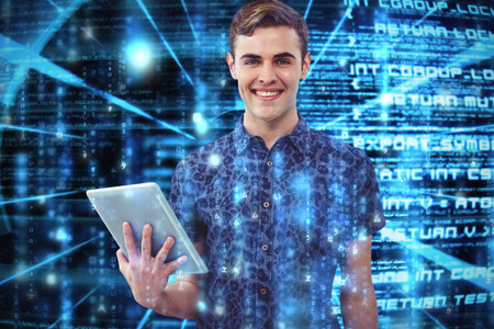 Handsome man with tablet against abstract blue text