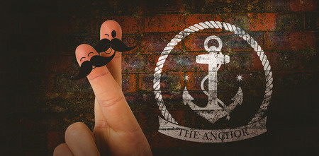 Fingers with mustache against texture of bricks wallの写真素材