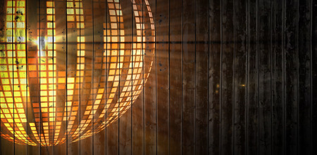 Wooden planks background against digitally generated cool disco ball designの写真素材